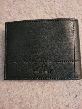 New, never used Perry Ellis black genuine leather wallet.